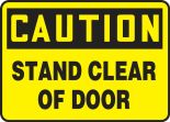 Safety Sign, Header: CAUTION, Legend: CAUTION STAND CLEAR OF DOOR