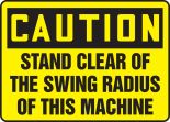 STAND CLEAR OF THE SWING RADIUS OF THIS MACHINE