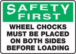 WHEEL CHOCKS MUST BE PLACED ON BOTH SIDES BEFORE LOADING
