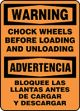 WARNING CHOCK WHEELS BEFORE LOADING AND UNLOADING (BILINGUAL - SPANISH)