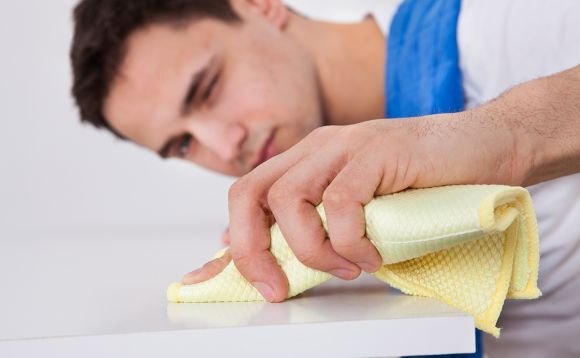 Man cleaning counter for part time housekeeping position
