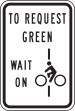 TO REQUEST GREEN WAIT ON (BIKE CROSSING OK SYMBOL)