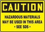 CAUTION HAZARDOUS MATERIALS MAY BE USED IN THIS AREA SEE SDS