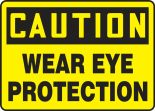 Safety Sign, Header: CAUTION, Legend: WEAR EYE PROTECTION