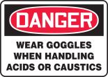 WEAR GOGGLES WHEN HANDLING ACIDS OR CAUSTICS