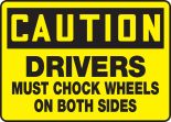 DRIVERS MUST CHOCK WHEELS ON BOTH SIDES