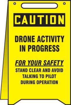 CAUTION DRONE ACTIVITY IN PROGRESS FOR YOUR SAFETY STAND CLEAR AND AVOID TALKING TO PILOT DURING OPERATION