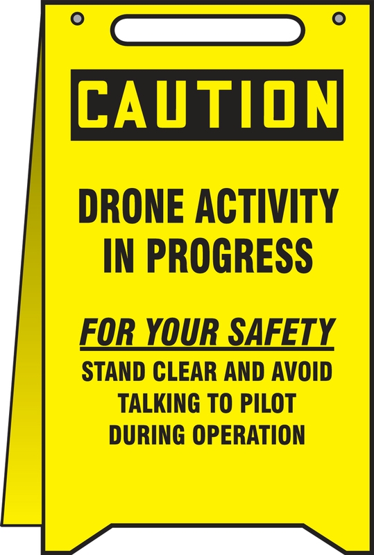 CAUTION DRONE ACTIVITY IN PROGRESS FOR YOUR SAFETY STAND CLEAR AND AVOID TALKING TO PILOT DURING OPERATION