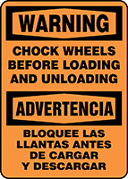 WARNING CHOCK WHEELS BEFORE LOADING AND UNLOADING (BILINGUAL - SPANISH)